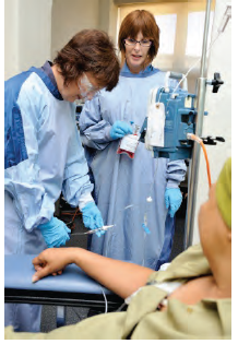 Photo of medical staff helping a patient