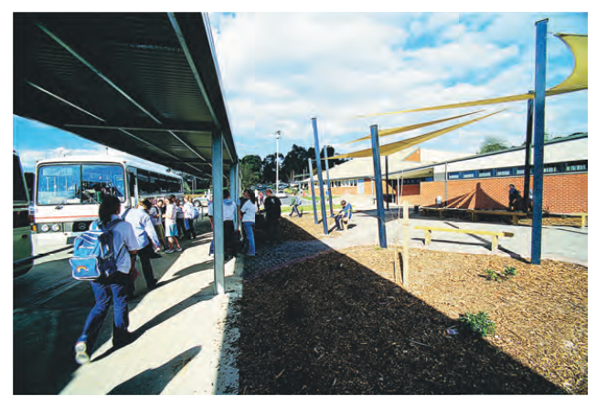 Photo of a bus stop and children outside a school. Photo courtesy of DEECD.