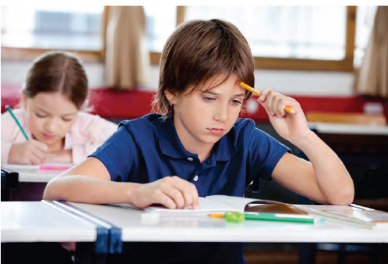 Photo shows a young boy and girl studying in a classroom. Photo courtesy of Tyler Olson/Shutterstock.