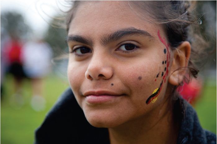 Image of a young girl with her face painted. Photograph courtesy of Tobias Titz.