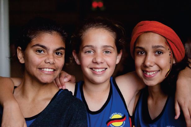 Image of three young girls embracing. Photograph courtesy of Tobias Titz.