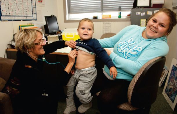 Image of a toddler and his mother with a doctor at the Gippsland Community Health Service.Photograph courtesy of Tobias Titz.