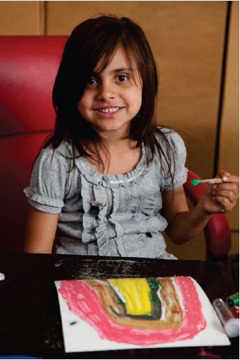 Image of a young girl painting.Photograph courtesy of Tobias Titz.