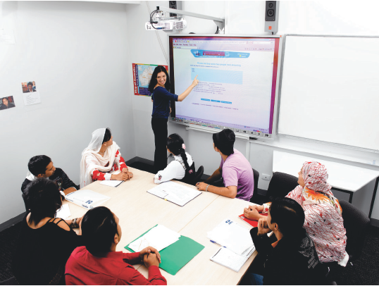 A teacher and various students in a class. Photograph courtesy of AMES.