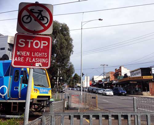 Image of a train at a level crossing.