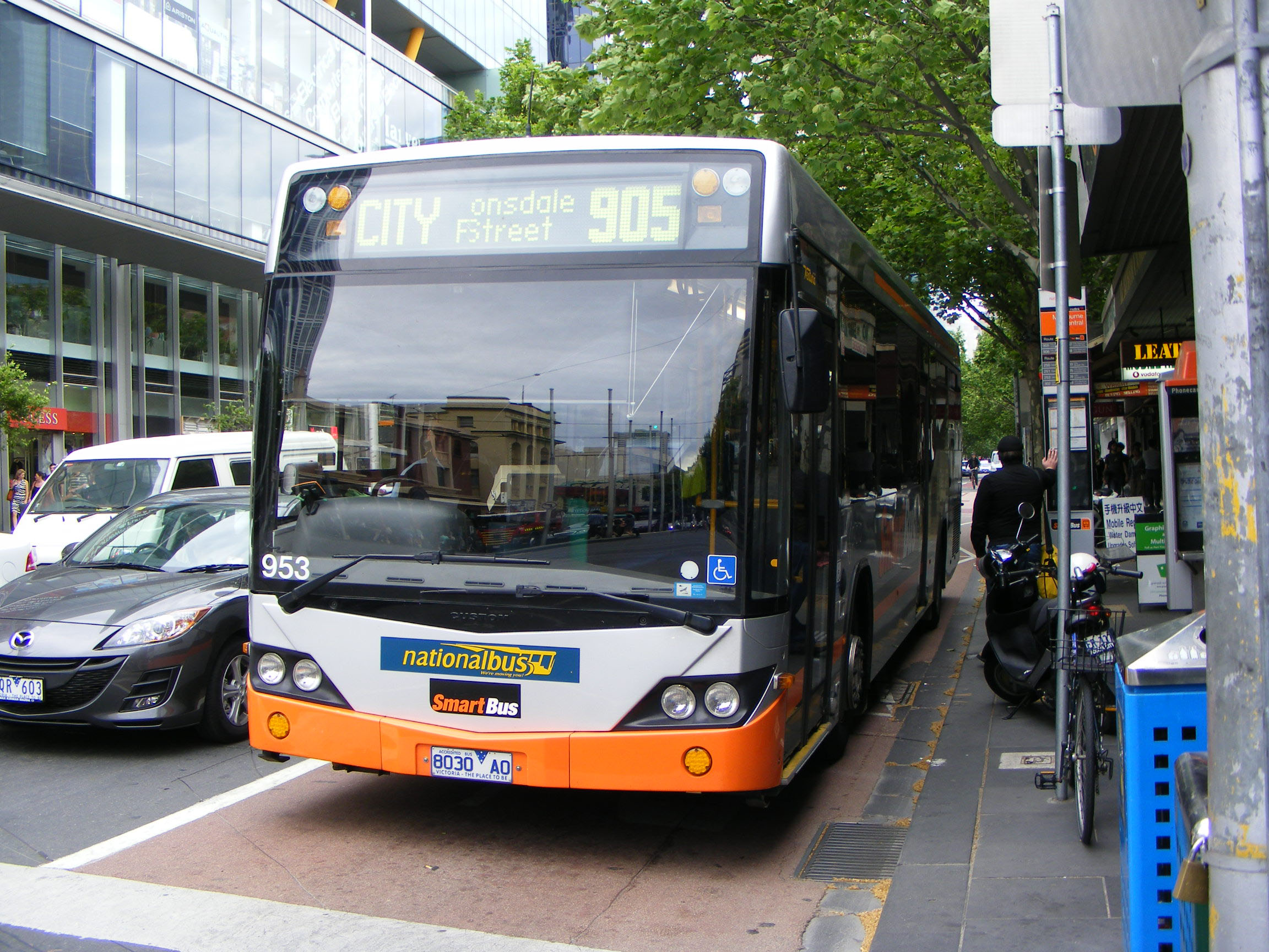 Image of a bus stopped at a bus stop.
