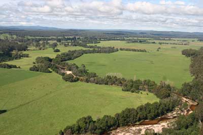The photograph shows the Cann River Floodplain looking downstream, showing a linked corridor of native vegetation along the riparian areas. 
Work undertaken under ECL tranche 3—Securing Priority Waterways.
Photograph courtesy of DEPI.