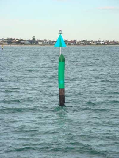 Starboard mark near Mordialloc Pier marking the entrance to Mordialloc Creek. Note special mark in the background delineating 5 knot zone. Photograph courtesy of Parks Victoria.
