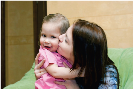 Image of a young girl smiling. Photograph courtesy of Vitalinka/Shutterstock.com
