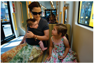 Image of a woman with a baby and a young girl. Photograph courtesy of ChameleonsEye/Shutterstock.com