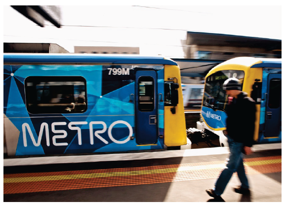 Photograph shows a train and a man on the platform