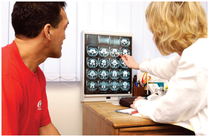 Image of a doctor and patient looking at scan results.