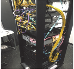 Network Video Recorder equipment kept in an unlocked rack with disorganised cabling