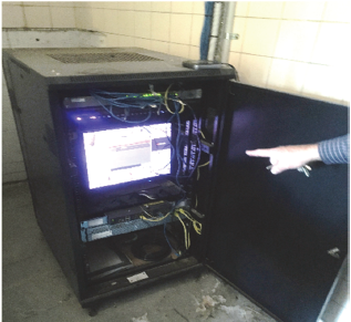 Public safety CCTV rack unlocked and hosted in the maintenance room for a public toilet, without any temperature, humidity or water detection controls.