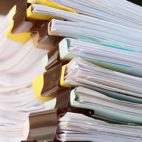 Stack of paperwork files. Photo courtesy of smolaw/shutterstock.com