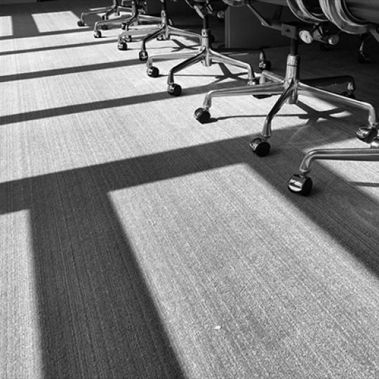 A row of chairs and shadows in the afternoon sun. Image by TBaker770/Shutterstock.com