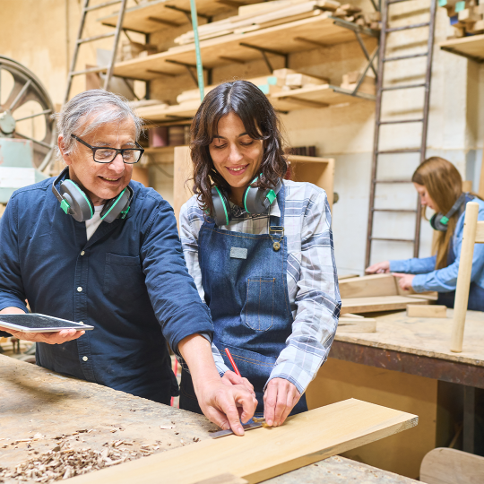 Student and teacher in a woodworking classroom