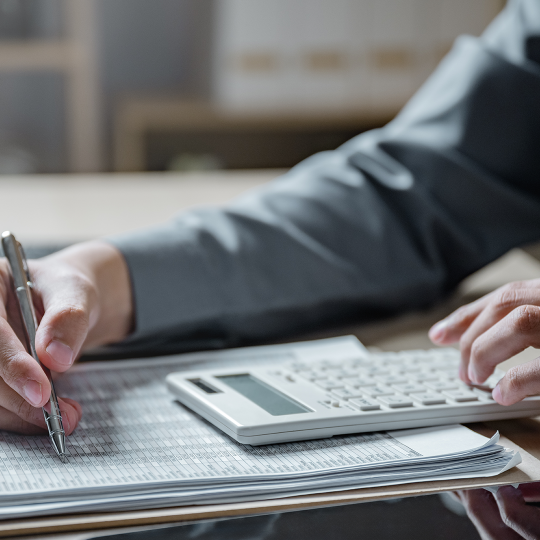 Person reading financial accounts and making calculations