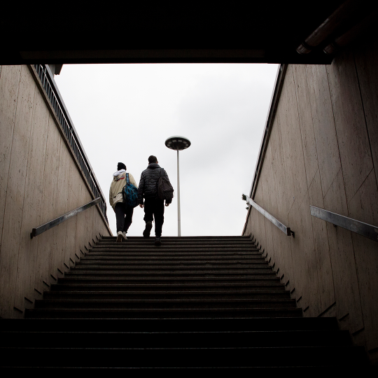 Two young people at the top of an external staircase 