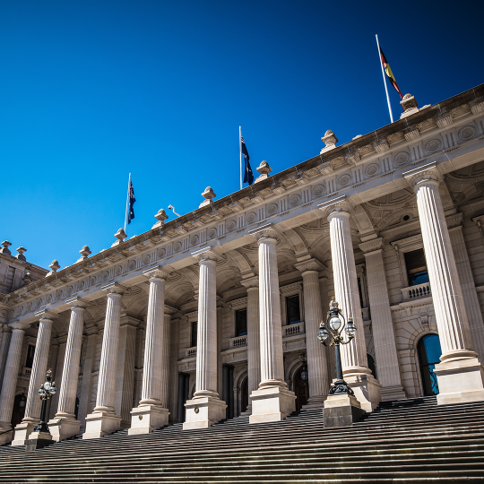 Parliament of Victoria facade and steps on a sunny day.