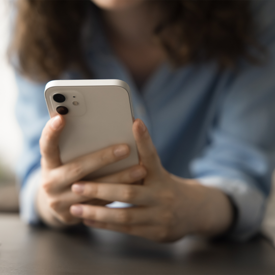 Close-up of person's hands holding a mobile phone