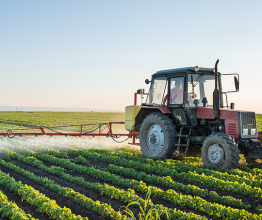 Fotokostic/Shutterstock.com - Tractor spraying soybean field 