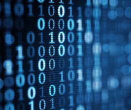 Image shows blue digital binary data on computer screen. Photo courtesy of gonin/Shutterstock.com
