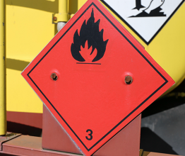 Image shows hazardous and flammable goods plate on a truck. Photo courtesy of Kenny10/Shutterstock.com