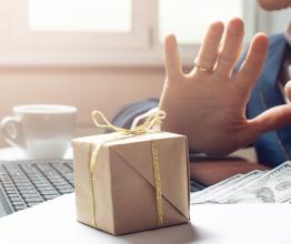 Businessman in suit refuses to take the bribe by showing that he was not corrupt. Photo courtesy of Artem Oleshko/Shutterstock.com