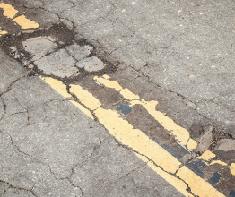 A damaged road surface. Photo courtesy of Tupungato/Shutterstock.com 