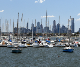 Melbourne skyline from St Kilda (Victoria Australia). View from a wooden jetty over the city of Melbourne in the Port Phillip Bay in Victoria and many yachts on the quay. Photo courtesy of katacarix/shutterstock.com 
