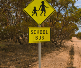 School bus sign on a dirt road in rural Australia. Photo courtesy of Mastersky/Shutterstock.com