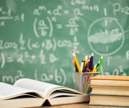 Image shows school books on desk. Photo courtesy of Cherries/Shutterstock.com