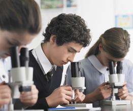 Image of High school students using microscopes in laboratory. Photo courtesy of sirtravelalot/Shutterstock.com