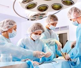 Image shows Team surgeon at work in operating room. Photo courtesy of Poznyakov/Shutterstock.com