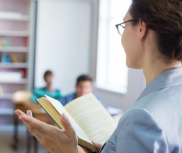 Image of a group of students listening to the teacher in the classroom at school. Photo courtesy of YanLev/Shutterstock.com 