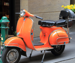 Image shows orange Vespa scooter parked on street in Melbourne. Photo courtesy of TK Kurikawa/Shutterstock.com