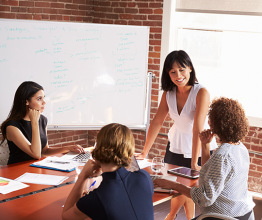 Group Of Businesswomen Meeting In Modern Boardroom. Photo courtesy of Monkey Business Images/Shutterstock.com