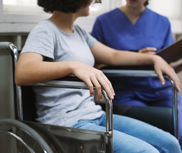 Lady in wheelchair next to a nurse. Photo courtesy of rawpixel.com/shutterstock.com
