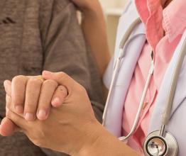 Doctor holding patients hand. Photo by Create Jobs 51/shutterstock.com