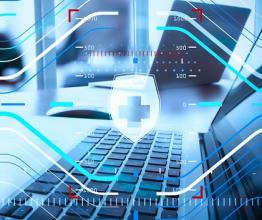 Abstract image of medical symbols and laptops. Image courtesy of everything possible/shutterstock.com
