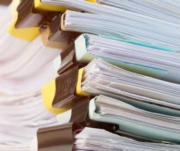 Stack of paperwork files. Photo courtesy of smolaw/shutterstock.com