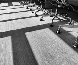 A row of chairs and shadows in the afternoon sun. Image by TBaker770/Shutterstock.com