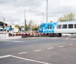 Train passing through level crossing in Melbourne.
