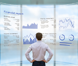 man standing in front of screen wall size display showing a financial report