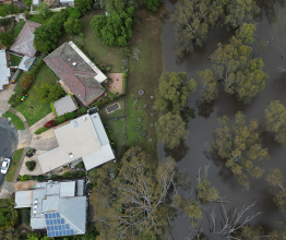 Aerial image of suburban houses next to a flooded area