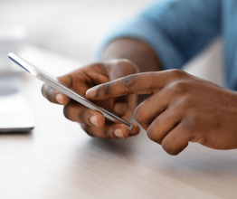 Hands browsing a mobile phone