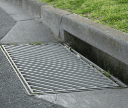 A new grated drain in a road