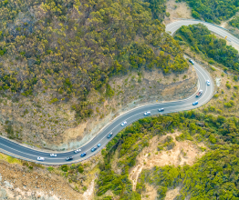 An aerial view of a road winding around wooded hills in Victoria.