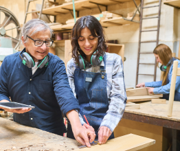 Student and teacher in a woodworking classroom